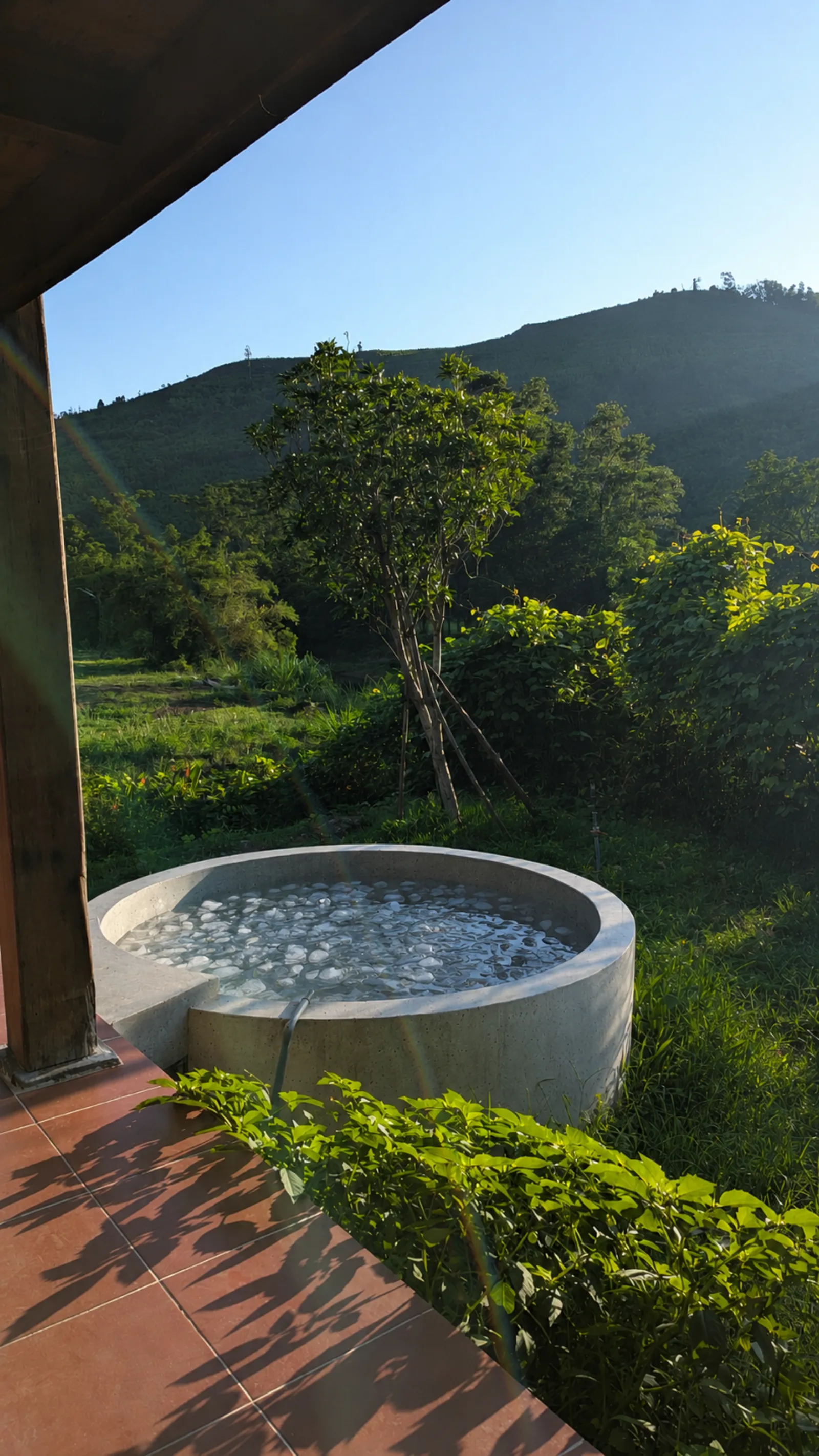 Stone ice bath on an open terrace overlooking the mountains of Da Nang